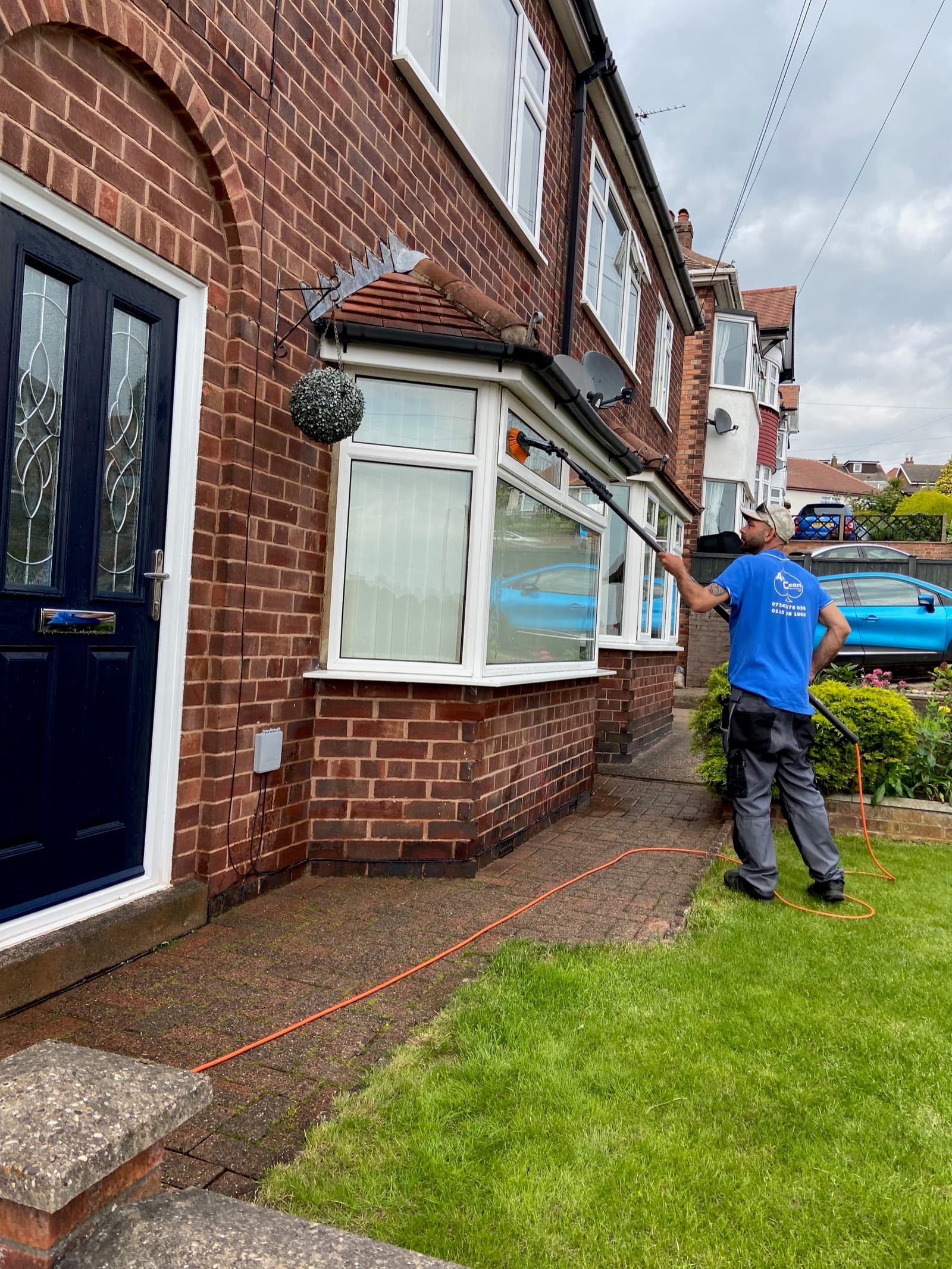 Ace Exterior operator pressure-washing a block-paved driveway