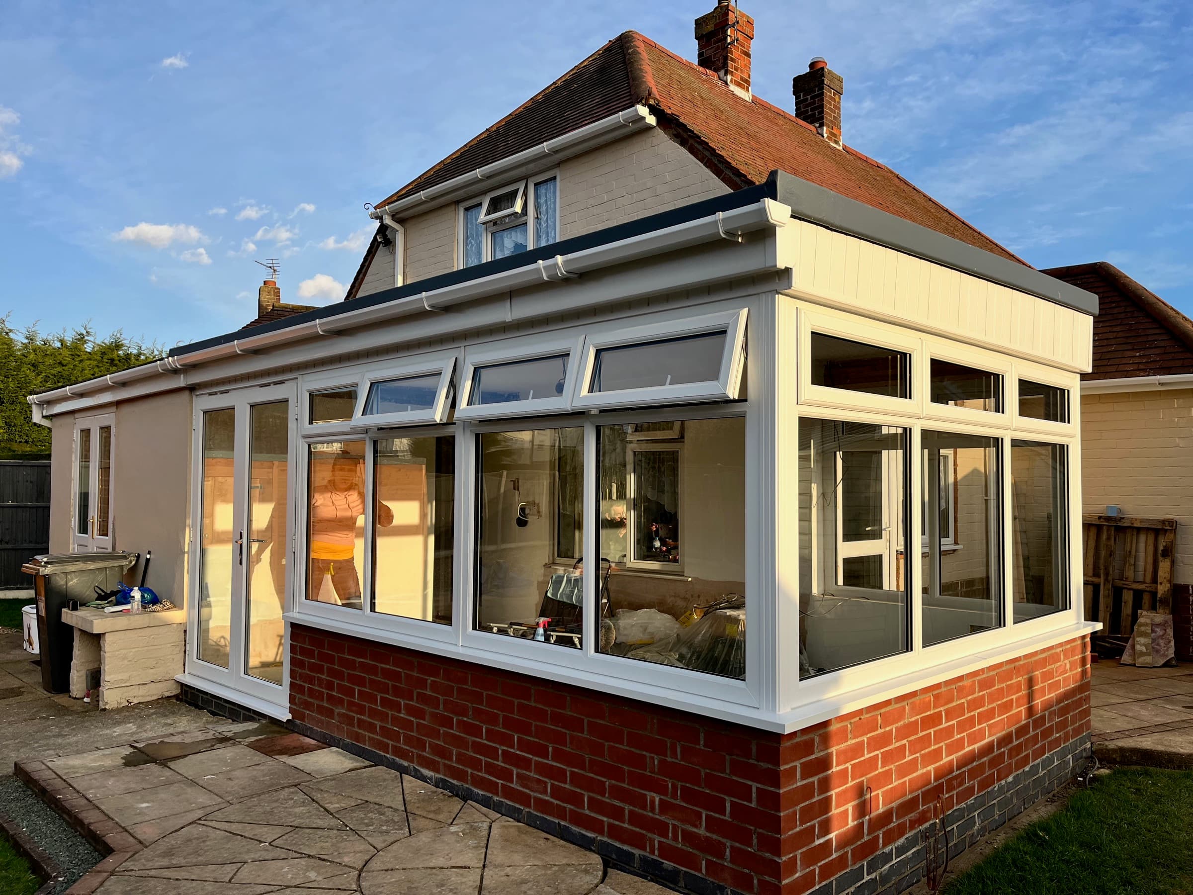 Freshly cleaned conservatory and house exterior at golden hour